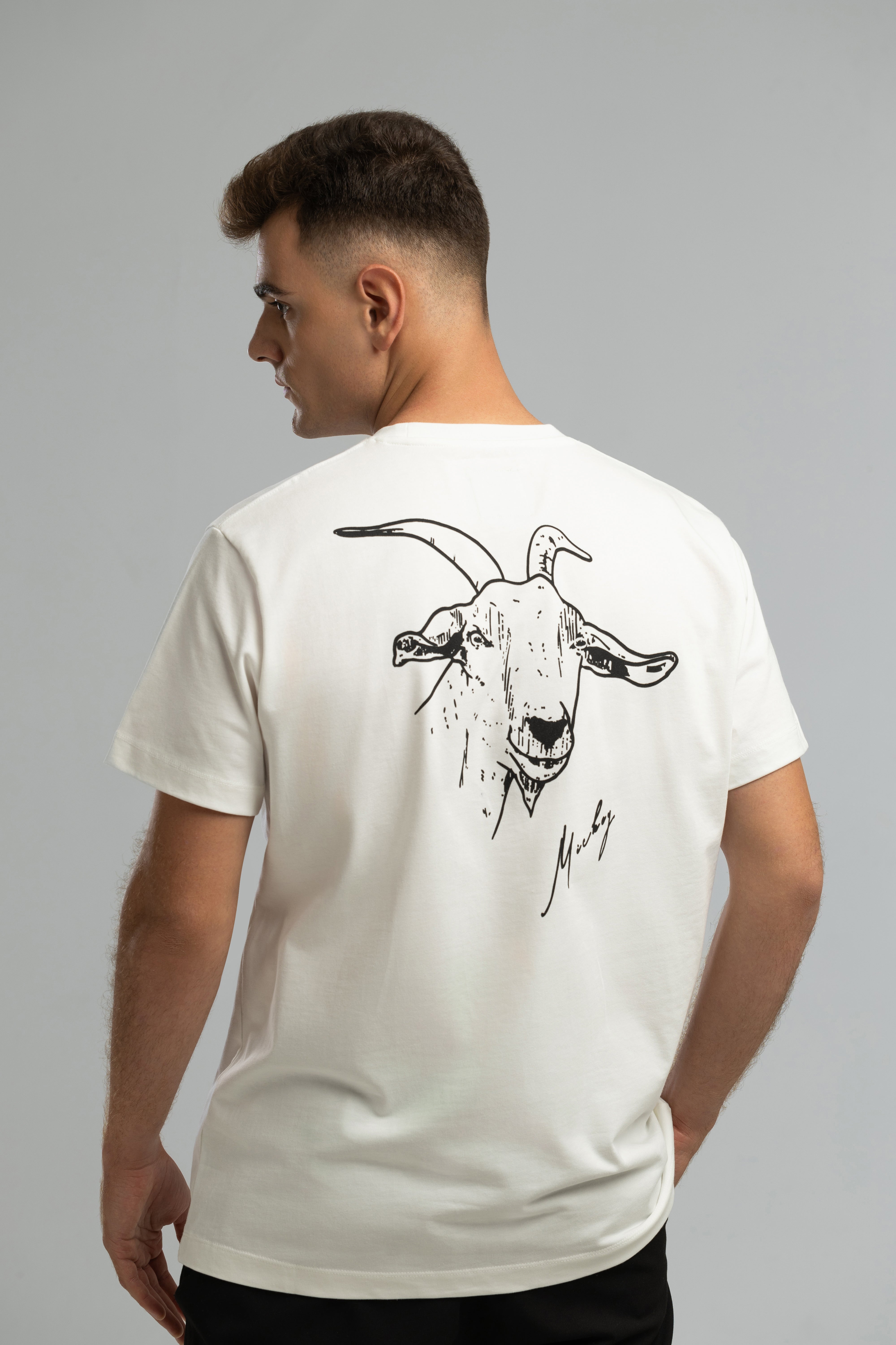 Ecrufarbenes T-Shirt im Stil von Mickey the Goat mit seitlichem Wilderness Cooking-Logo